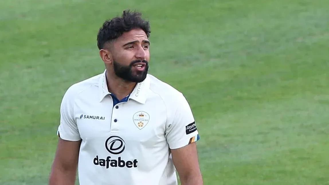 Cricketer in white uniform during match action