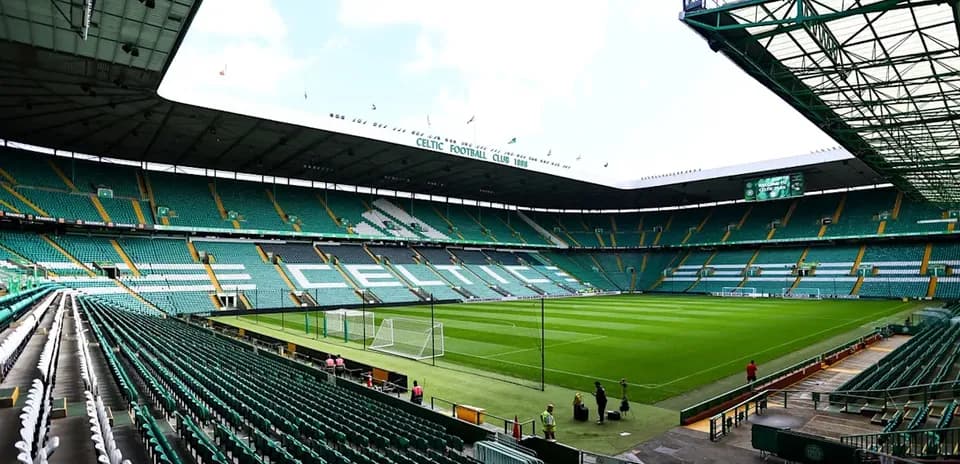 Empty Celtic Park stadium with green seats and pitch