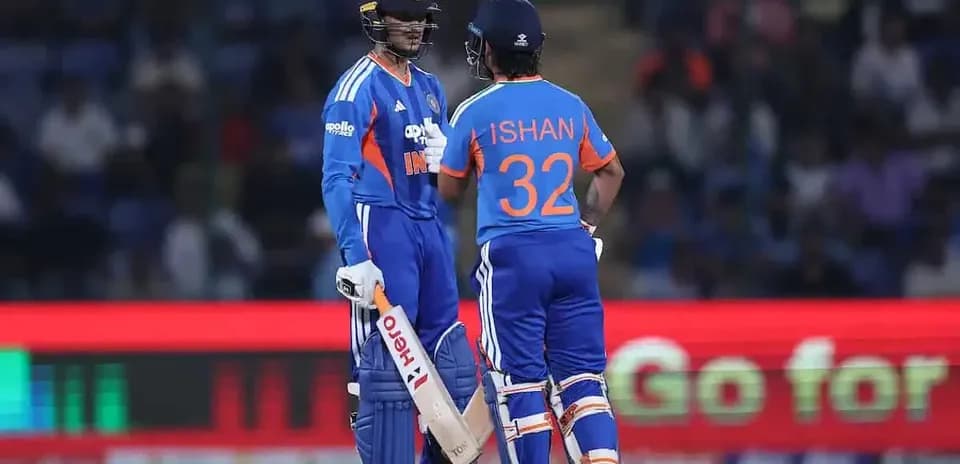 Two Indian cricketers discussing strategy on field