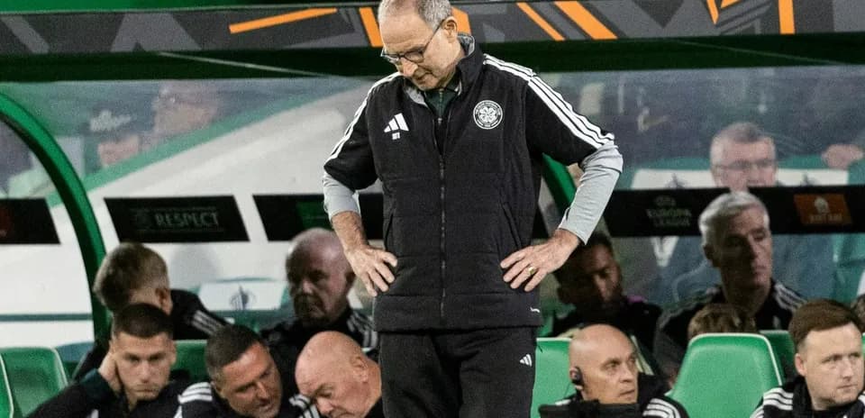 Manager standing on sidelines with concerned expression