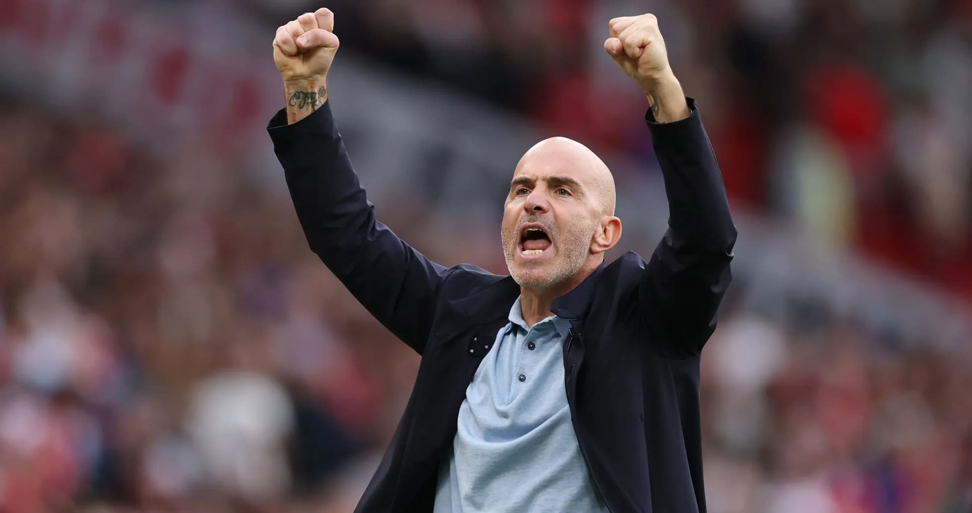 Coach celebrating a goal with raised fists