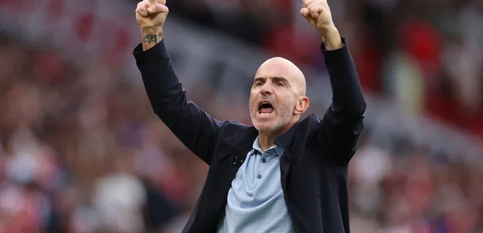 Coach celebrating a goal with raised fists