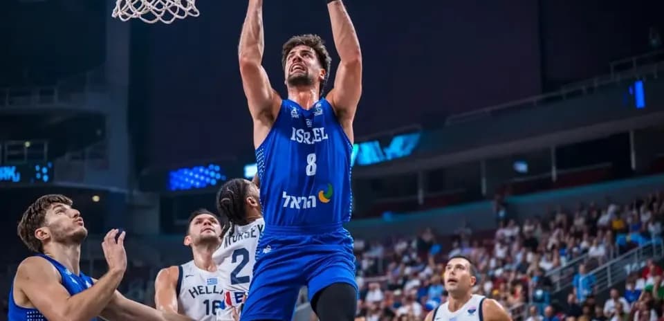 Player from Israel scoring during basketball game