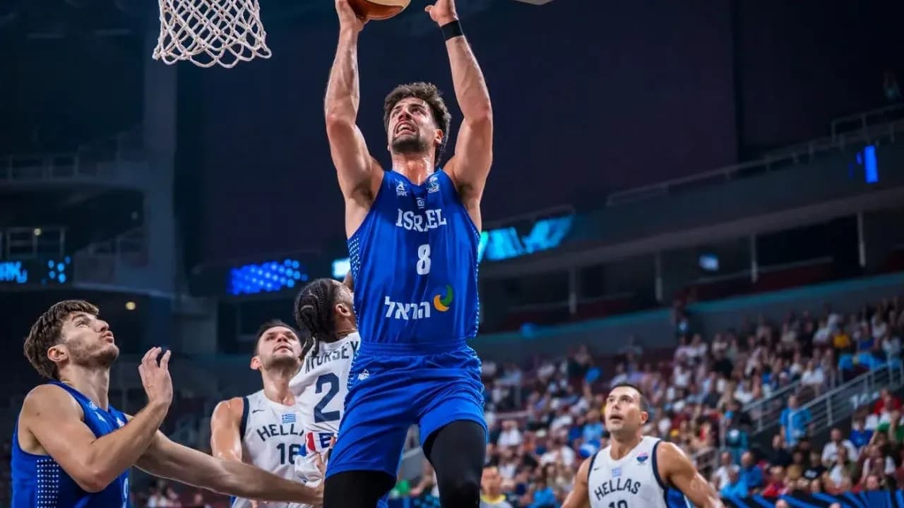 Player from Israel scoring during basketball game