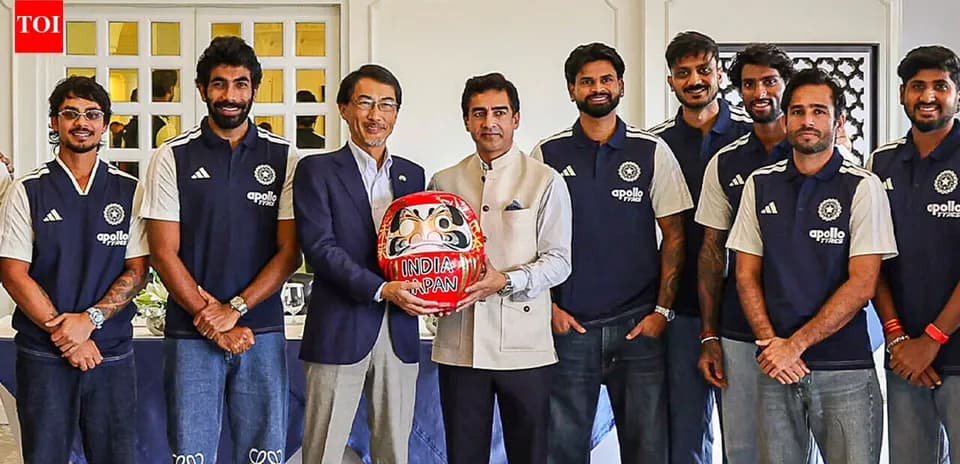Cricket team posing with a Daruma doll
