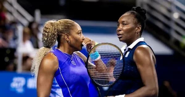 Two female tennis players discussing on court