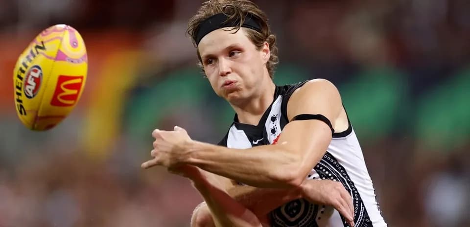 Player kicking an AFL ball during a match