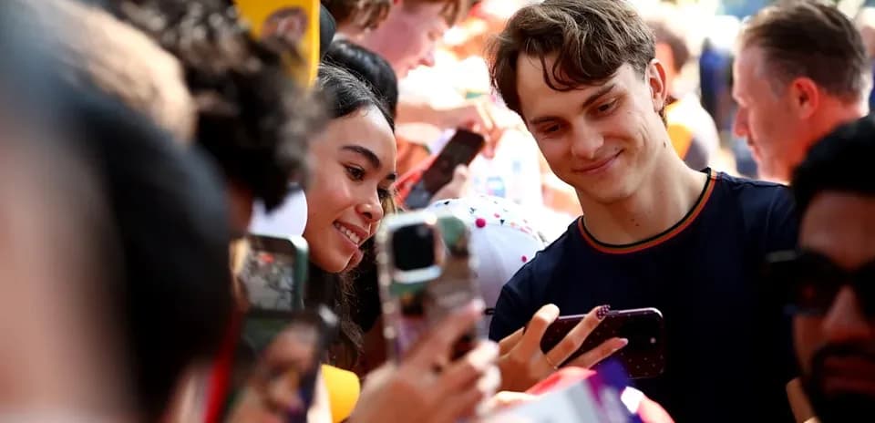 Fans taking selfies at a public event