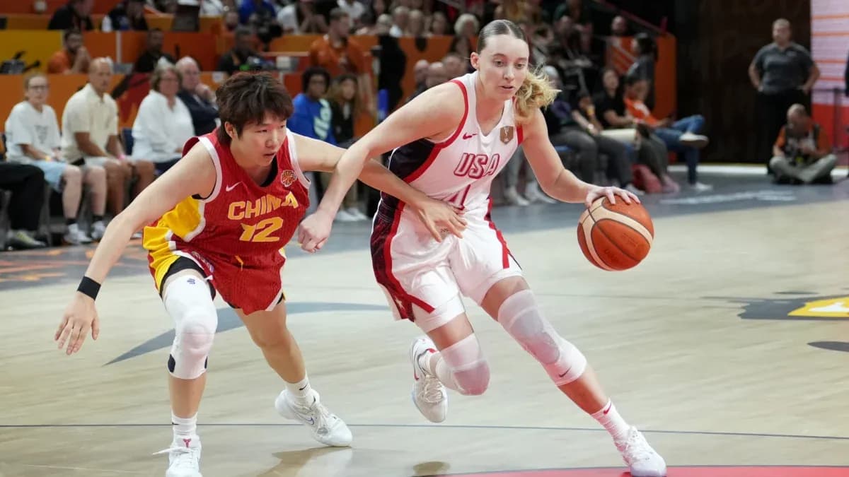 USA player dribbling past China player during game