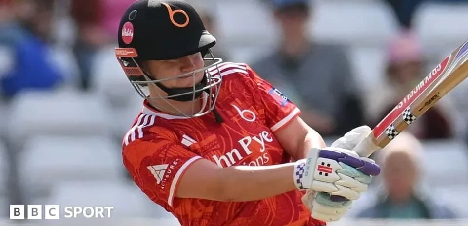 Batter striking the ball during a cricket match
