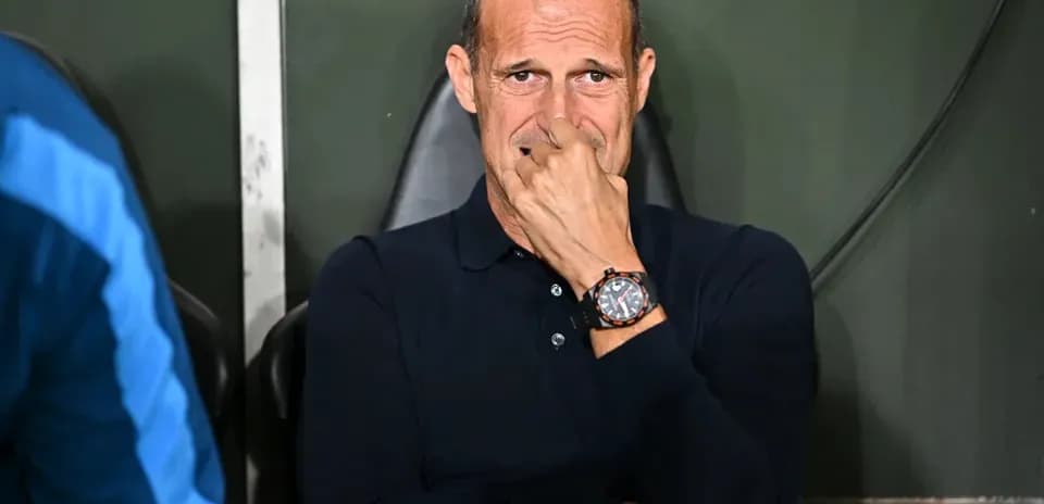 Coach seated on bench during a match
