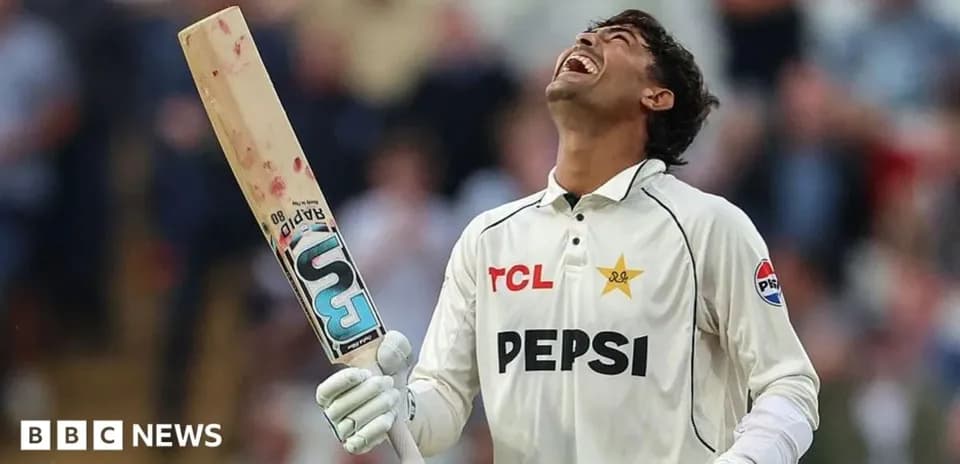 Cricketer celebrating with bat raised after scoring