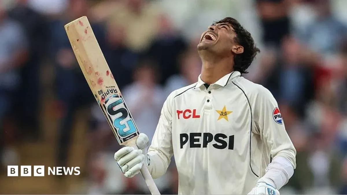 Cricketer celebrating with bat raised after scoring