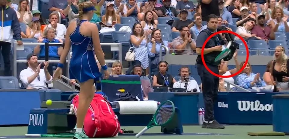 Tennis player on court with spectators applauding