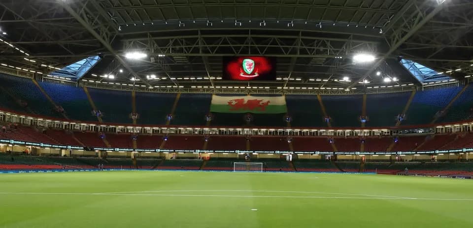 Empty stadium with Welsh flag and scoreboard