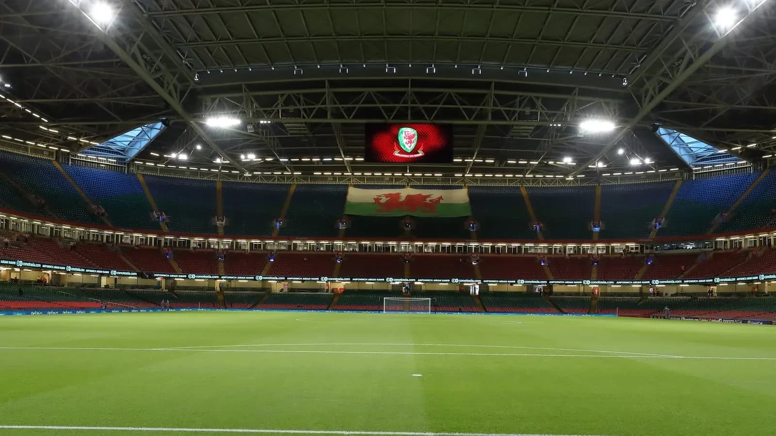 Empty stadium with Welsh flag and scoreboard