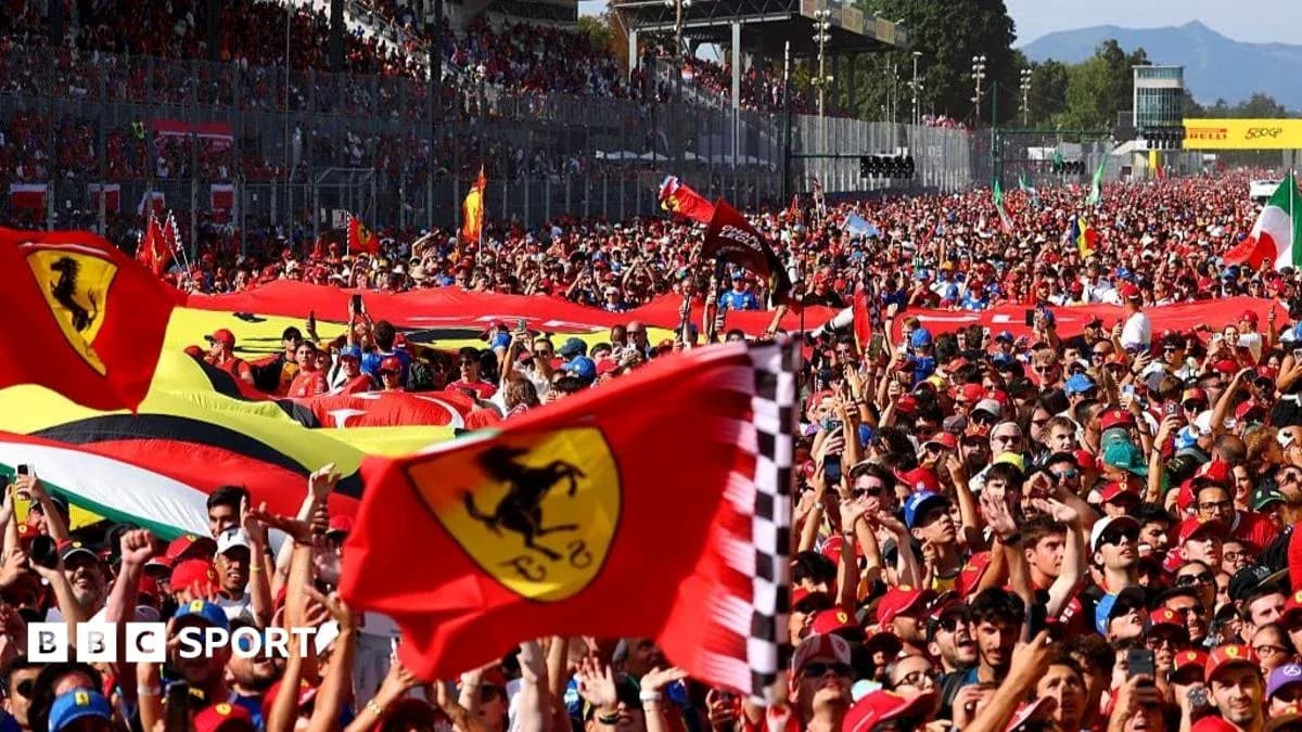 Large crowd of Ferrari fans waving flags at event