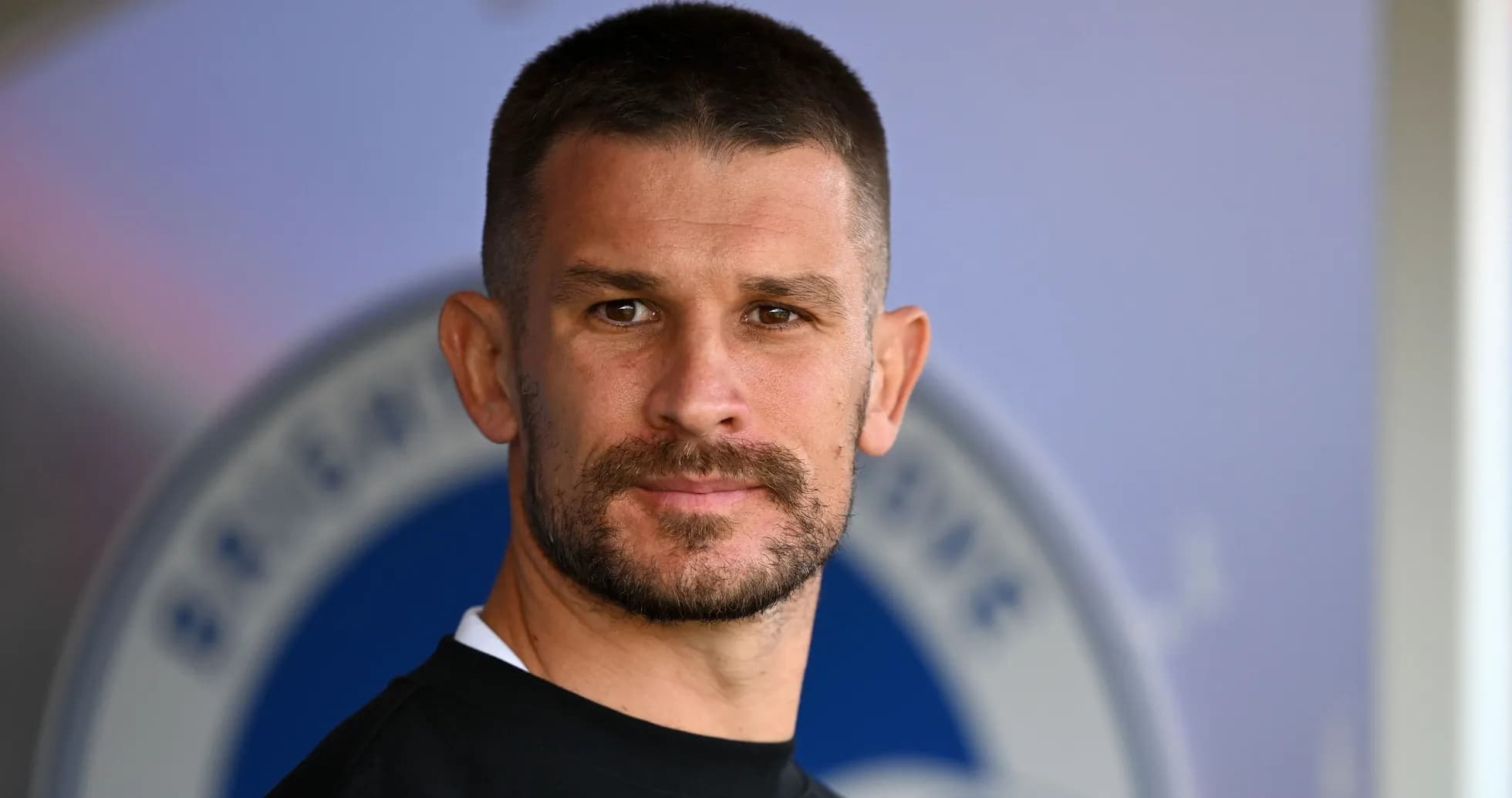 Player posing for a portrait in training gear