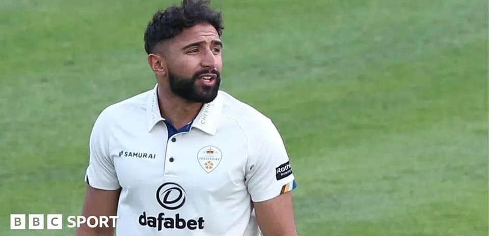 Cricketer in white kit on the field