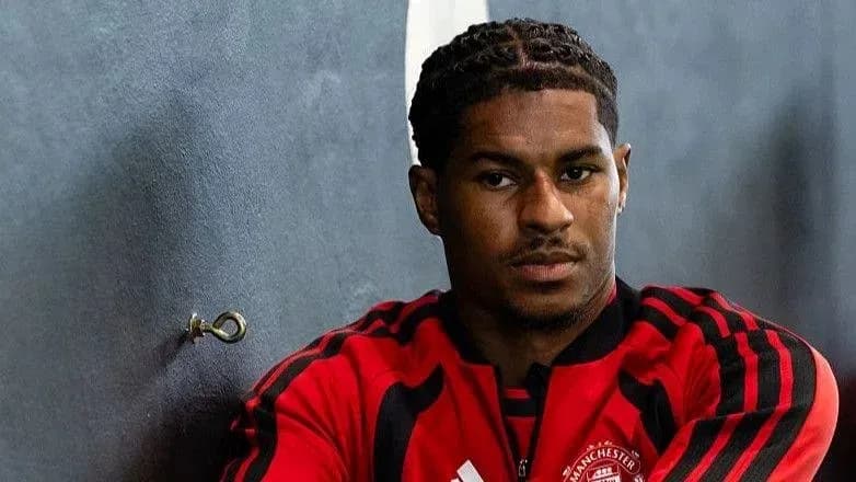 Player sitting against wall in training attire