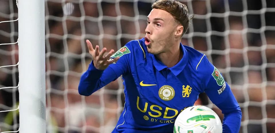 Player in blue jersey gesturing with ball in hand