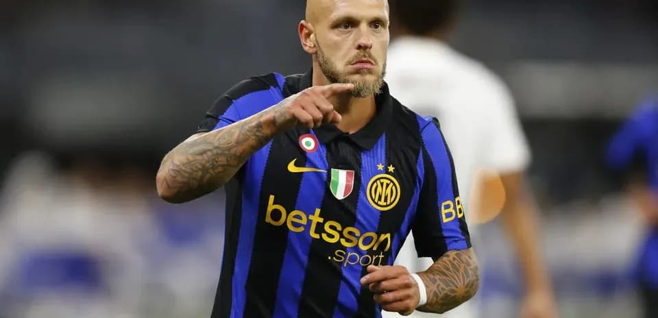 Player in blue and black jersey celebrating on field