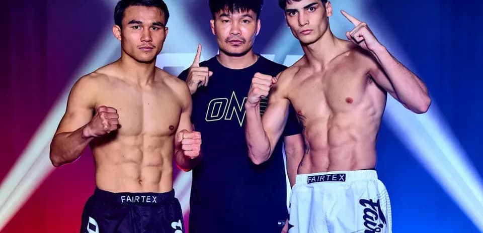 Two fighters posing with coach before match