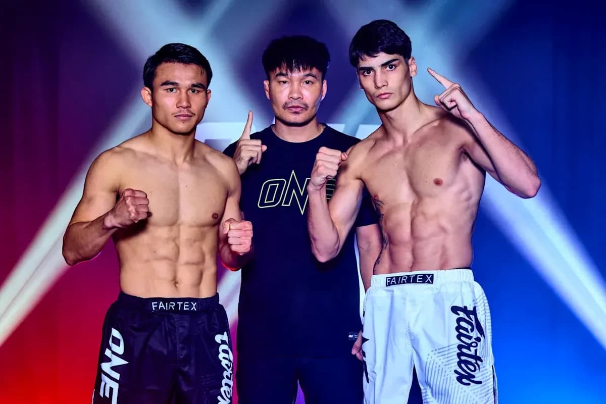 Two fighters posing with coach before match