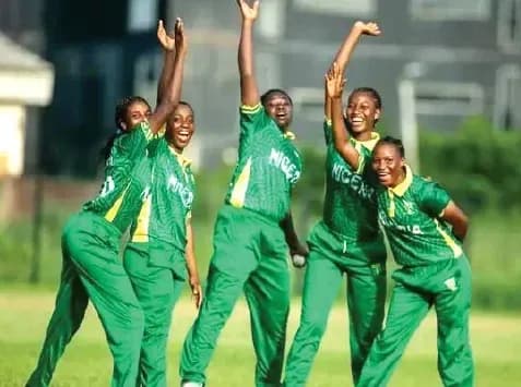 Five Nigerian women cricketers celebrating on field