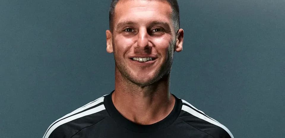 Football player posing in team training kit
