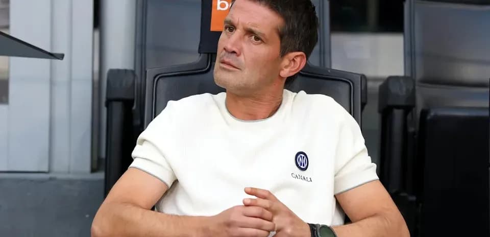 Manager sitting in the dugout during a match