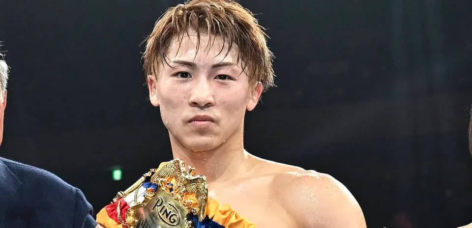 Boxer holding championship belt after victory