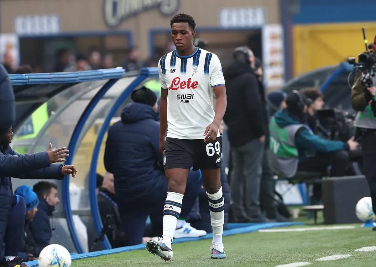 Player walking off the pitch towards bench