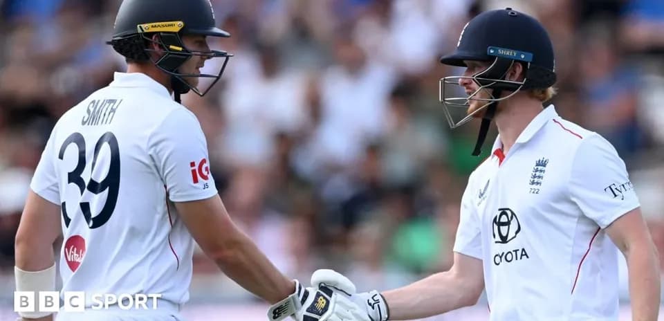 Two cricketers shaking hands during match celebration
