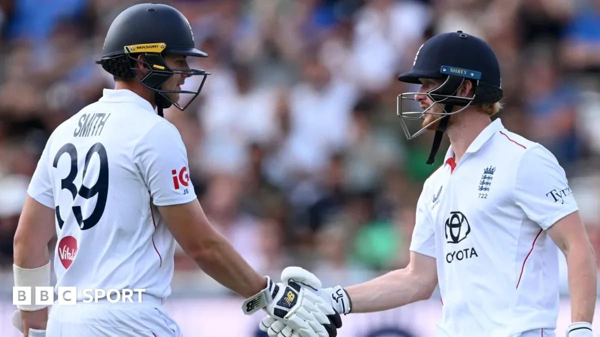 Two cricketers shaking hands during match celebration