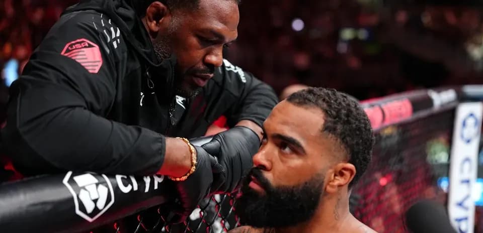 Coach advising fighter in the octagon corner