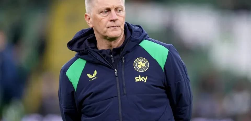 Coach observing players during warm-up on pitch