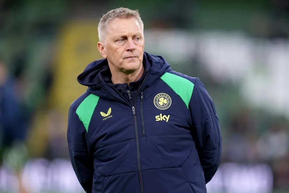 Coach observing players during warm-up on pitch
