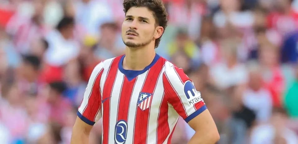 Atletico Madrid player during match with fans in background