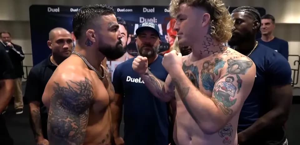Two fighters facing off during weigh-in event