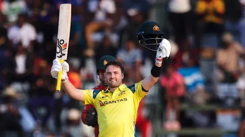 Batsman celebrating century with raised bat and helmet
