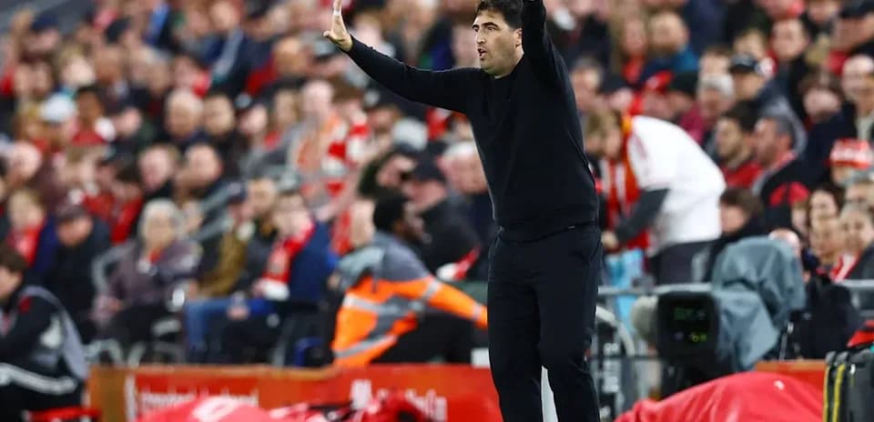 Coach gesturing from the sidelines during match