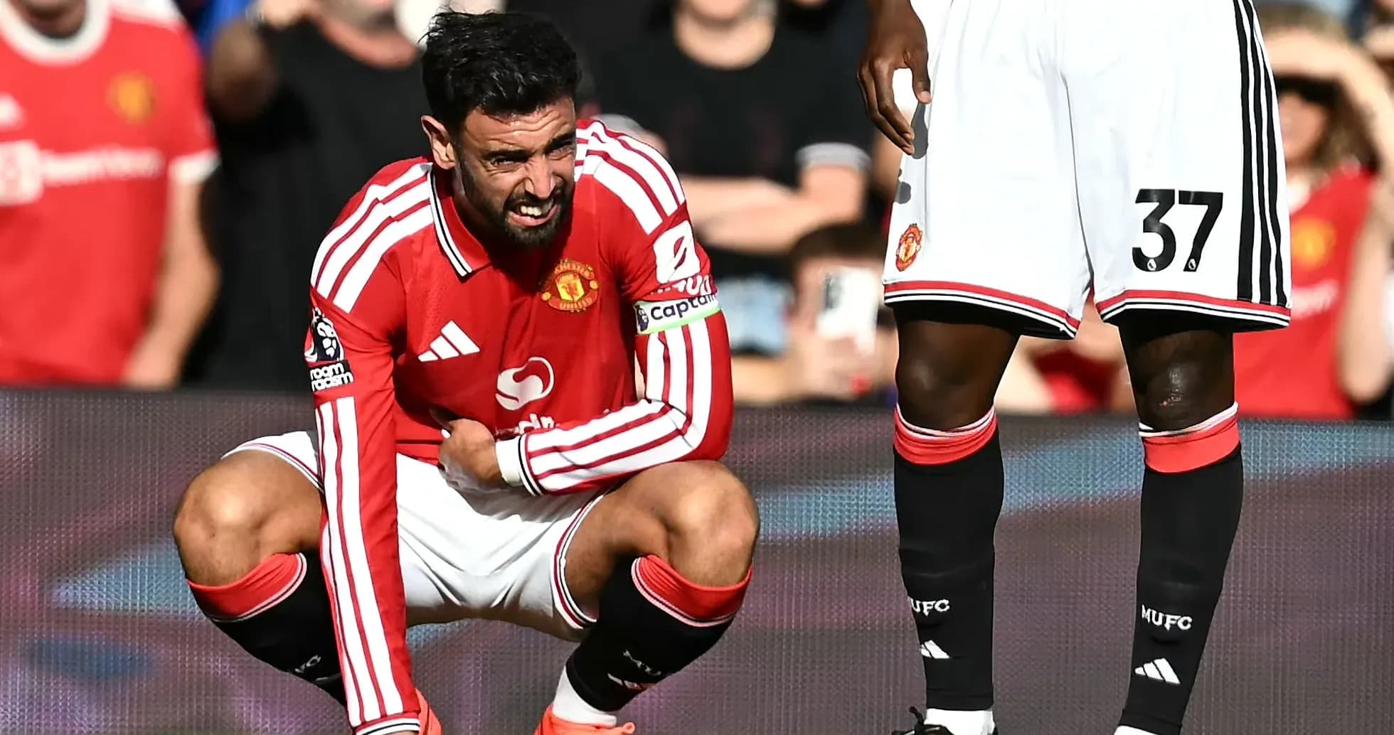 Bruno Fernandes crouching in pain during match