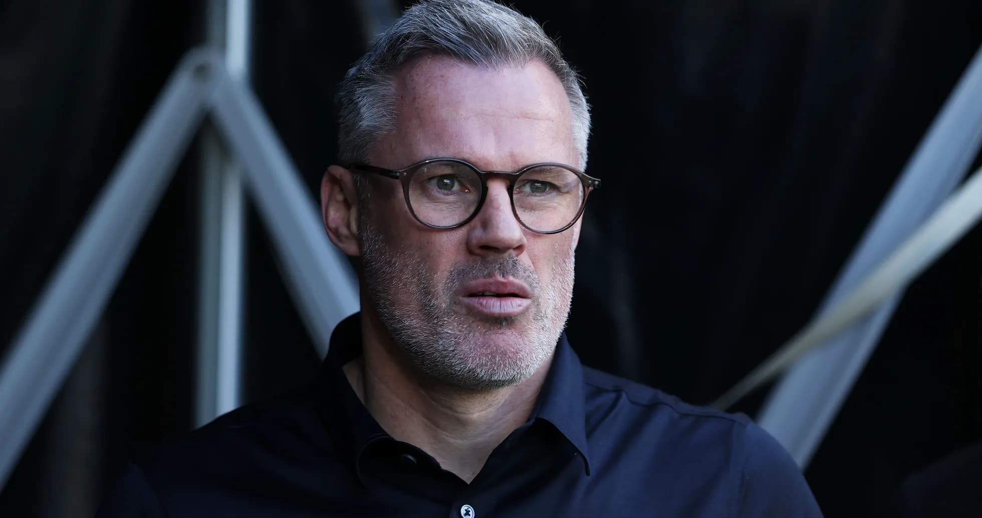 Man in glasses looking thoughtfully off-camera