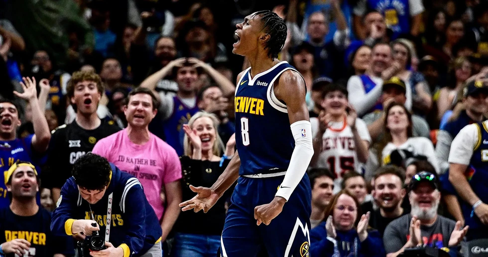 Player celebrating in front of enthusiastic crowd