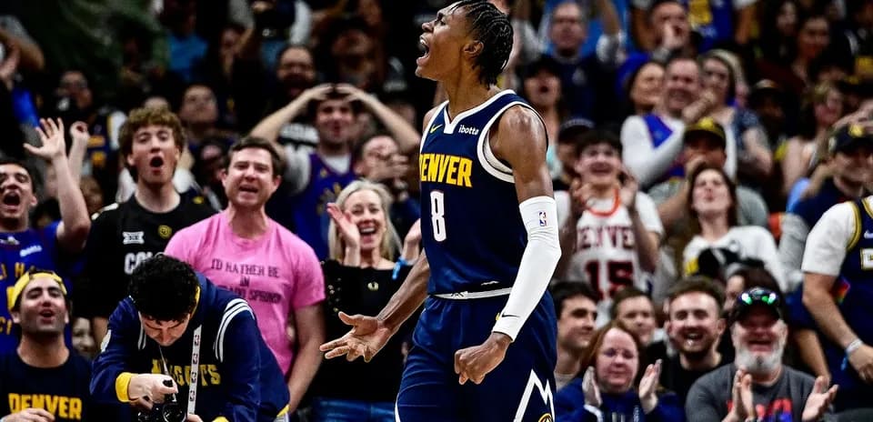 Player celebrating in front of enthusiastic crowd