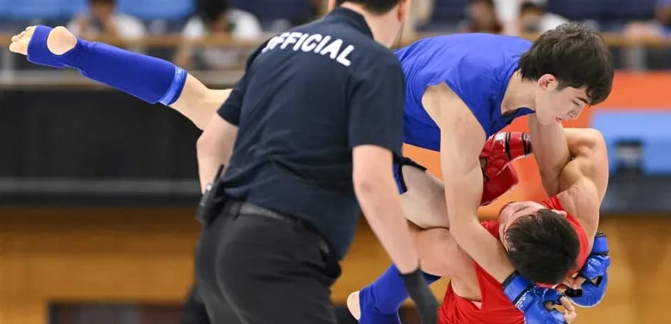 Two fighters grappling in a martial arts match