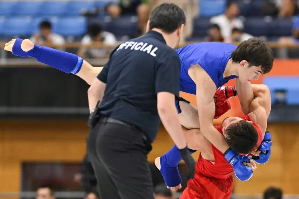 Two fighters grappling in a martial arts match