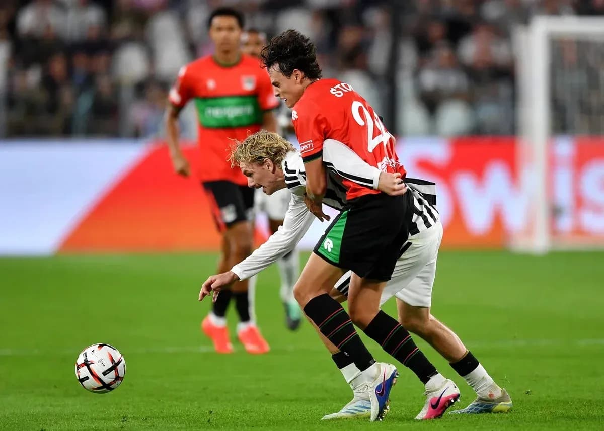 Two players contesting for the ball on field