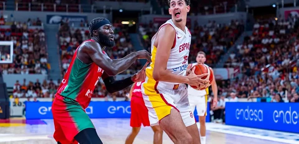 Player from Spain holding the basketball, defender reaching